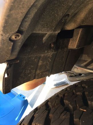 trimmed wheel well guard. Bottle still slightly exposed but mechanicals protected.