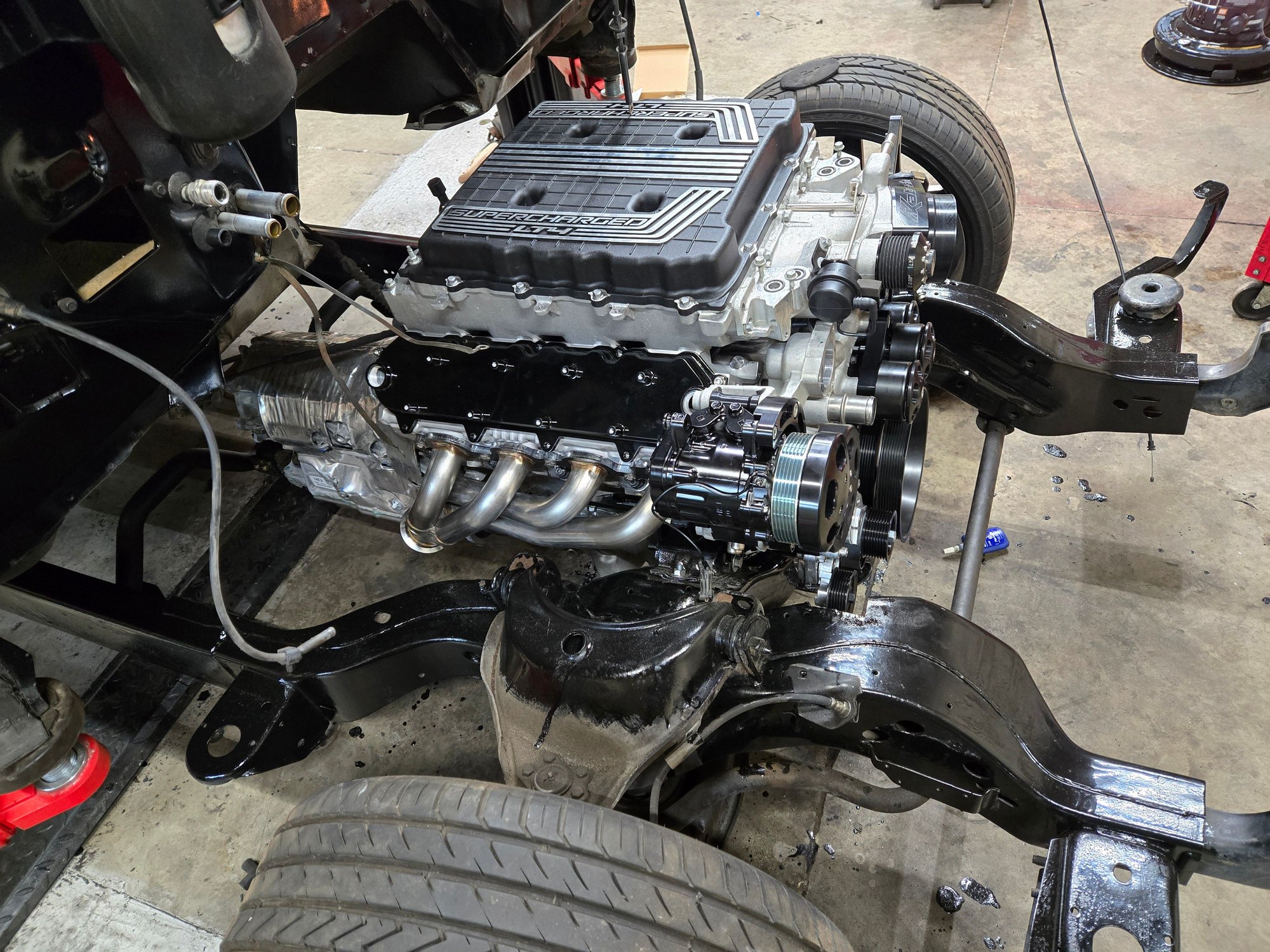 Stock manifolds hit frame... bolted these cheap shorties on there fpr now but got some long tubes on order