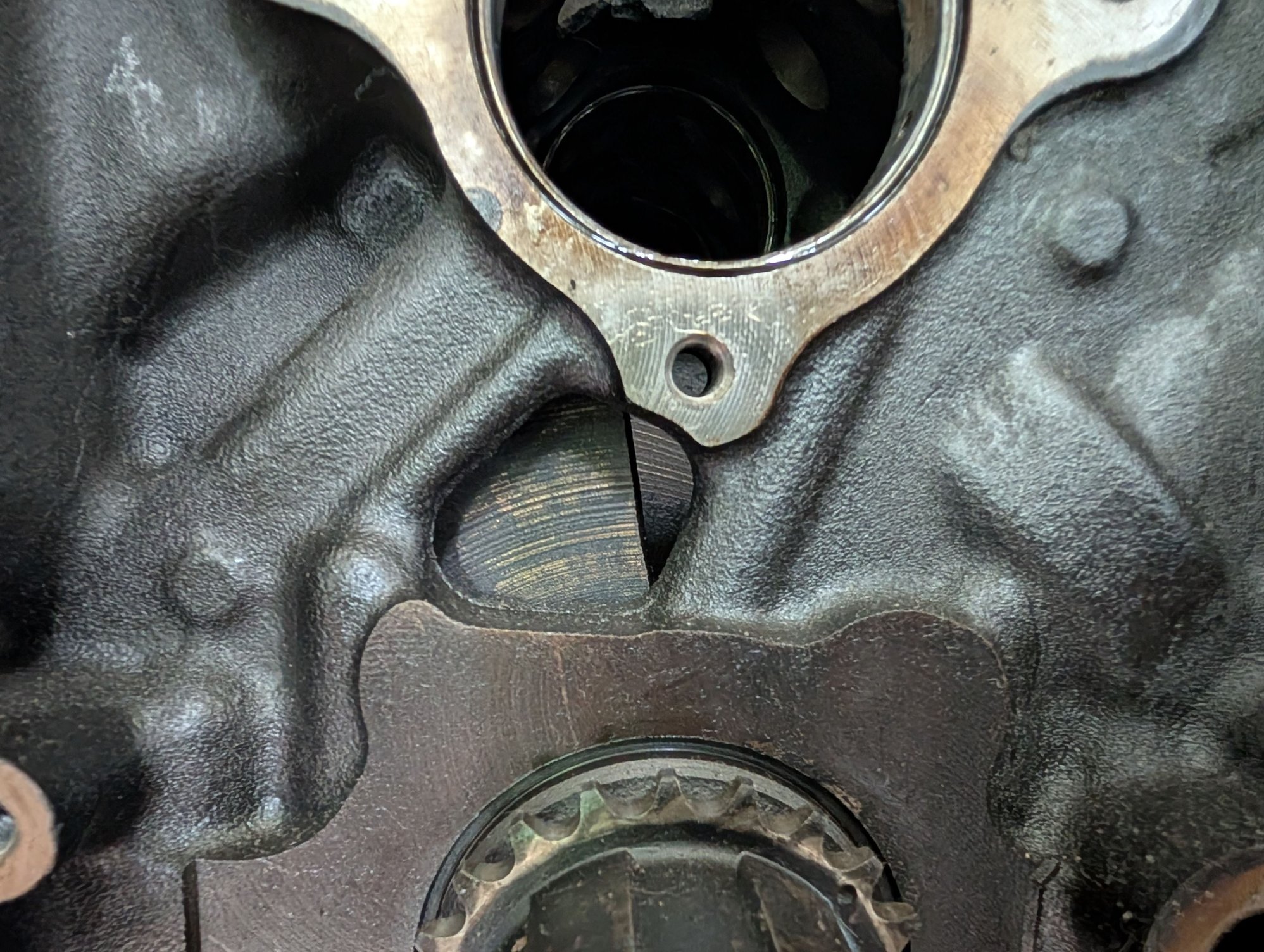 Make sure you use the right bolts For the camshaft retainer plate. They are the same thread as the oil pan, But the ones for the cam plate are shorter. If you put a longer one here it would be hitting scraping scratching on the front of the crank there