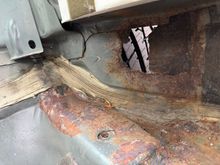Driver wheel well/next to rear seat