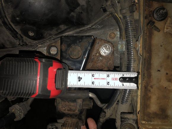 Battery tray on the right----edge of mount at about 1-1/2 inches???