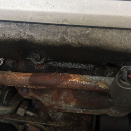 On the bolt and to the right of it