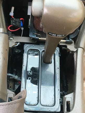 Shifter does not move without some help. I have to use a flat head to push the lever over to go into gear. This is the shift interlock solenoid that has failed. The trim and cigarette lighter are both in the trunk. Also it looks like the previous owner tried to wire a USB port to the cig lighter 