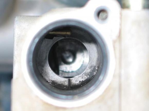 5. hole for flapper closeup, raised part of flapper goes into lowered portion of hole edge at right