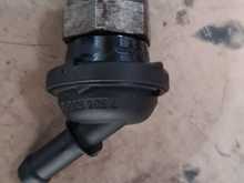 This is the faulty valve. It is attached to a hose. And this goes from the block to the intake. Crankcase vent hose which incorporates the valve.