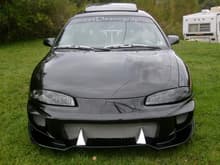 Front end shot showing the 
Wings West Aggressor body kit with fangs and the black HID projector headlights.