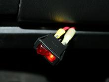 Red toggle switch under the lower dash panel.