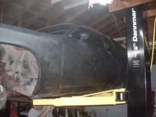 Another lift view. Tom in the background cutting off the old mufflers, they were spot welded on.