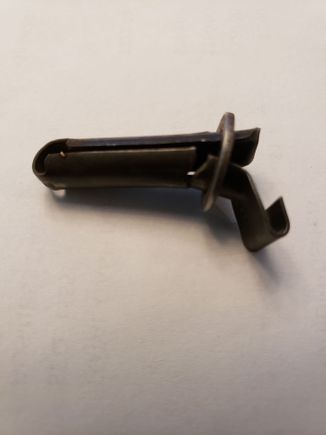 Reverse light switch trigger lever. This activates the spring loaded back up light switch.