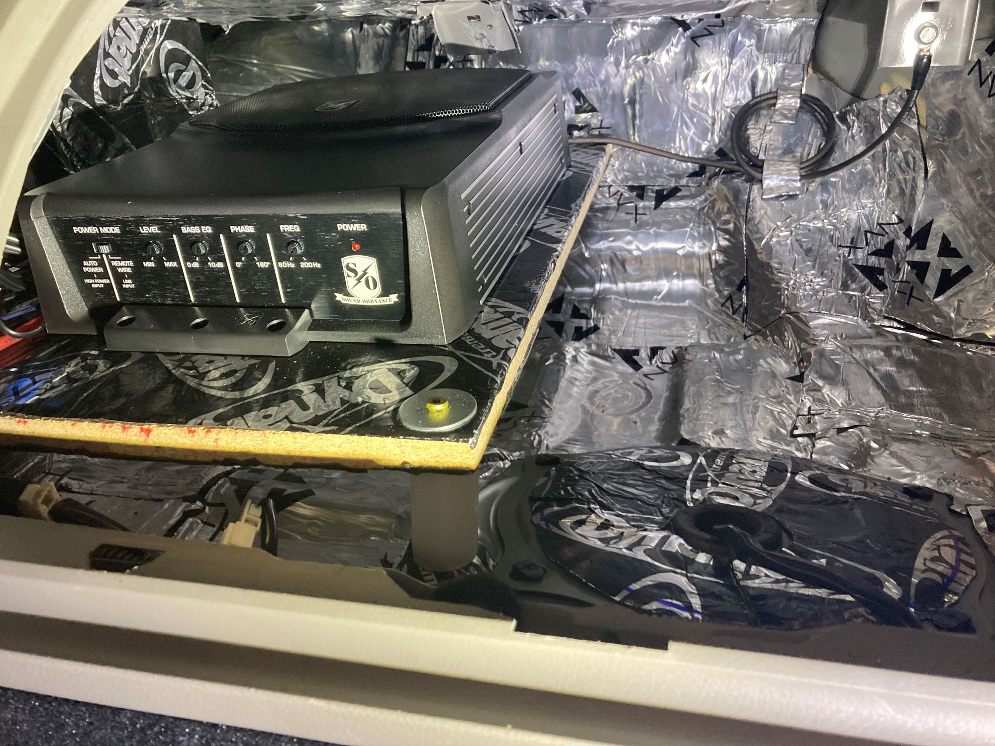 Here is the final install.  I had to bend the bracket on the top of the enclosure back a little bit so it didn't hit the top of the sub.  Wires are hidden pretty well and if I need to service the sub, the three screws on the front holder come out, and it just slides under the one in the back.  It sounds great here.  Really good resonance, clean, tight, no rattles.  And still lots of space here if needed.