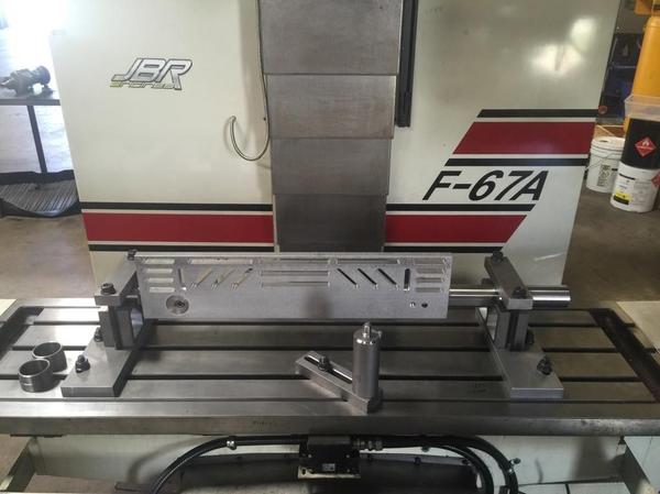 Cylinder head holding and leveling fixture for a CNC