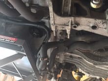 cross member and coolant lines disconnected. Hydraulic table under engine