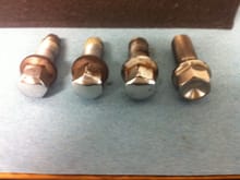 old rusted lug bolts with adjacent titanium lug bolt