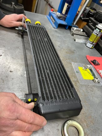 Finishing touch on oil cooler, mounting plastic tabs to direct air flow to oil cooler 