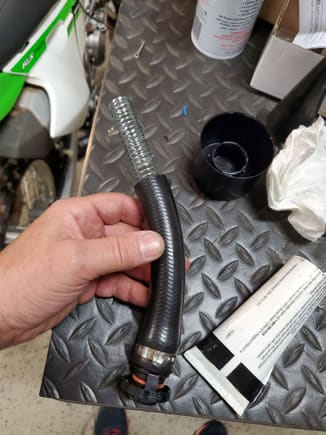 Used some scavenged AOS hose ends to make the hose that will connect to the OEM AOS outlet.  Because it will have a bend in it and I don't want it to kink, I installed a spring into the hose.  This also prevents collapse under vacuum.