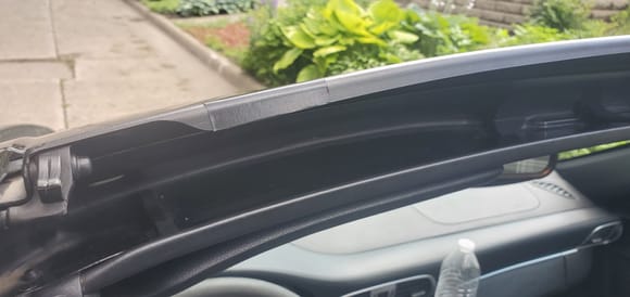 Tape applied to the air deflector is the most visible, but I don't see it while driving.  And when parked I always close the roof. 
