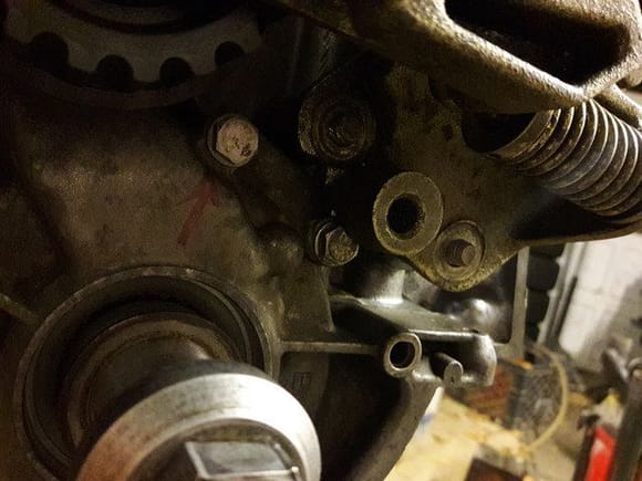 You can see the bolt is too high and fouls the tensioner where the empty bolt hole is.