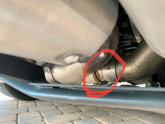 Perspective is from rear of vehicle passenger side shooting forward.  Valve inside pipe is circled.  You can see lower pivot of butterfly valve on bottom.