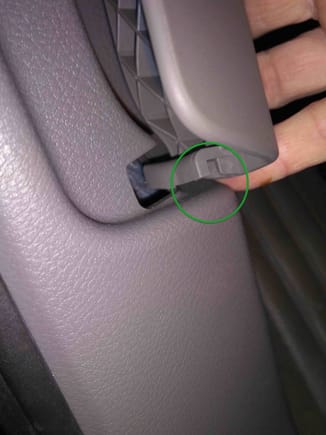The groove and its mate on the door sill trim prevent the handle from being pulled sideways