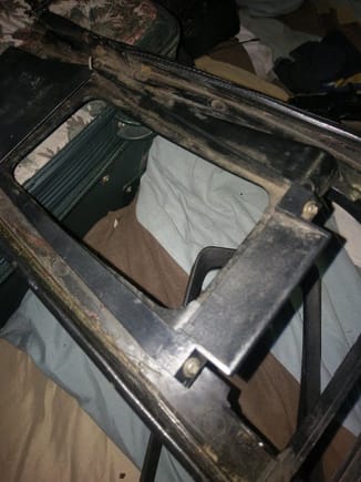 You can see this plate thing screwed to the underside of the console frame. There is a "wing" extending under the ashtray opening, as well as one not clearly shown here under the window switches.