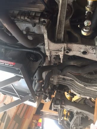 cross member and coolant lines disconnected. Hydraulic table under engine
