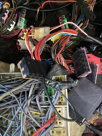 First one. Traced the two grey wires. One goes to the 15amp fuel pump/O2 sensor fuse, then to U15. Other goes to pin Q14, which goes to U15. They are connected as they should be, but oddly rather than connecting thru U15 plug it’s all taped together!? 