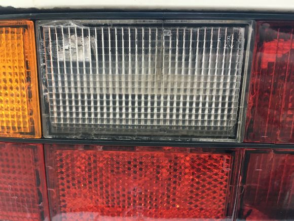 Taillight lense here in the middle a little discolored. Bit of water inside. And some cracks/crazing.