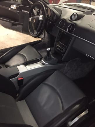 Cayman S interior ... has factory full leather in black and gray and pained console.  Also PASM, Sports Chrono and PCM 2.1 with extended Nav