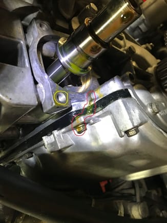 Red outlined area is the oil leak path.  Yellow circle shows where the bolt with oil on it was.  (Note that oil was not dripping from this bolt area when assembled). 