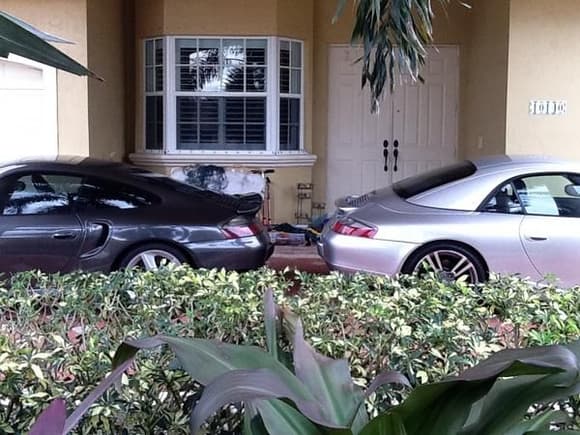 Porsches backed in the driveway