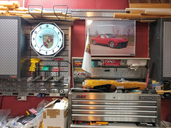 Lighted Porsche wall clock next to a pic of my first P-car - a '73 914 I got when I was 16.  About half the parts from that car are in my current black one