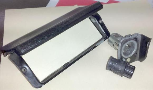 Used Mr. Dremel to grind out welds on old cig lighter. Made a face template from file folder material, which in this photo is the same color as the background.