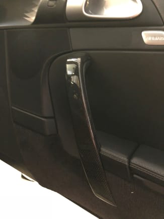 Passenger door pull bar in carbon fiber 

I want to buy (or trade for) OEM piece in black base finish (not grey or alcantara)