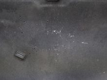 Oil splatter after driving on the underside of the hood