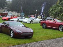 our Vantage, someone's new Bentley to the right, Ferraris behind, McLaren in the background. 1963 red E-Type way at the back