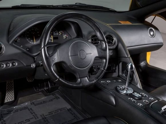 Before: OE black leather Murcielago steering wheel
