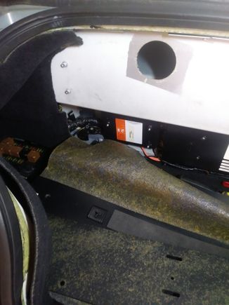 Front of the trunk, left side with the top of the rear sub frame mount exposed.