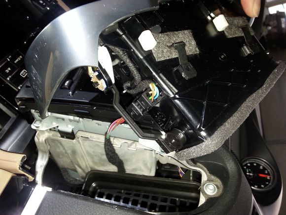 this is the side view of the vent after it's out.  see the 2 black metal pieces with gray felt material? it goes through so when you pull on the tabs on the other side, it retract a little.  that's all that is holding the vent in-spring loaded.