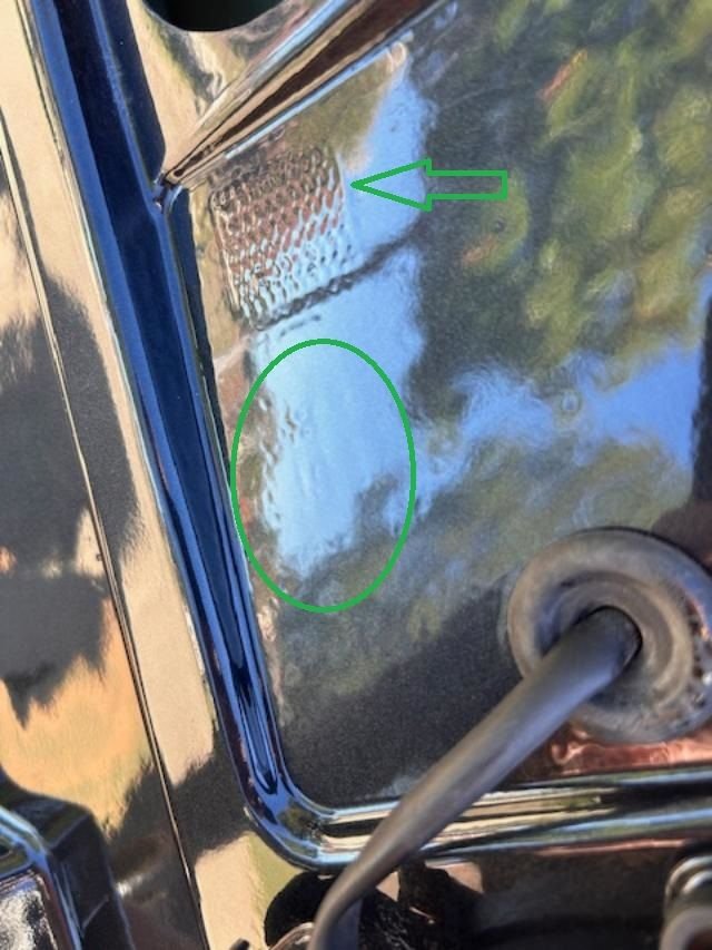 OEM part # is paint over (oval circle). Note the wavy square emboss that exist only on OEM wing.