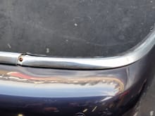 rear bumper, rusty screw in trim.