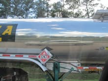 Even though distorted, the car looks nice reflected on the side of a Dana Transport tank trailer. Trailer built by Bulk Equipment, Division of Brenner Tank LLC. A division of Walker Group Holdings LLC. Don't ask how I know all that!