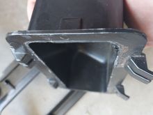 I shaved off the lip that interfaces with the rest of the black center console insert.