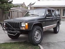 Put on the front Grille Guard/Bumber that i got off my jeeping buddy. Got my ugly stock rims on there, with some bald @ss tires.