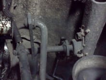 Photos of my transfer case shifter linkage.  This photo shows a scabby weld on a bracket under the driver's side floor/tunnel.