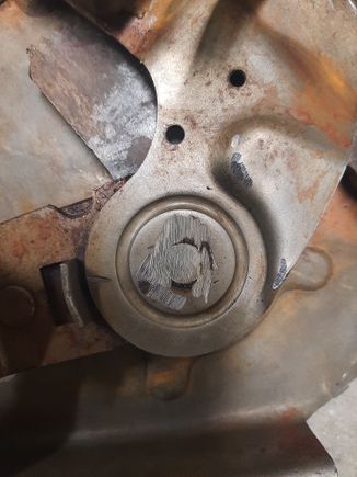Rivet head ground down to disassemble the bracket.