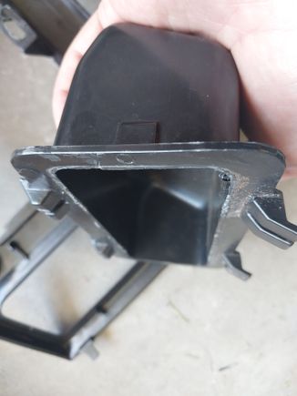 I shaved off the lip that interfaces with the rest of the black center console insert.