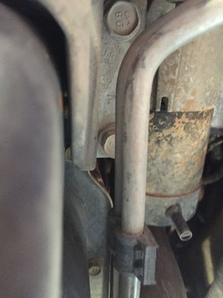 Aim for the middle of this pic with kitchen knife or screwdriver, even, as you are under the jeep's passenger front wheel well with your head pointing to front.