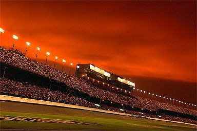 Sunset at Daytona, July Busch Race, 2004. I snapped this off from our pit stall right before the race. We dodged the big one with a little RF fender rub, but ended up getting taken out by Kenny Wallace in some hotshot, banzai move.