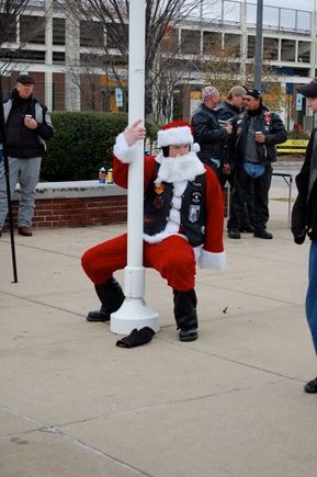 Santa doing a little pole dance. Don't let the kids see this.