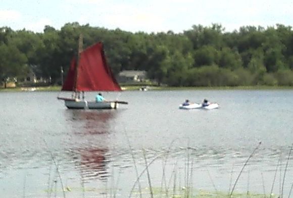 My stepdad's sailboat... And yes, he is pulling my sister and her friend behind him